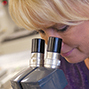 woman looking into microscope